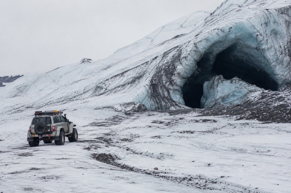 Editorial illustration of a modified four-wheel-drive vehicle beside a glacier