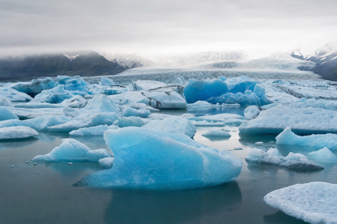 Drifting blue icebergs on the still water of Jokulsarlon glacier lagoon, the main stop on the Diamond Beach day tour from Reykjavik